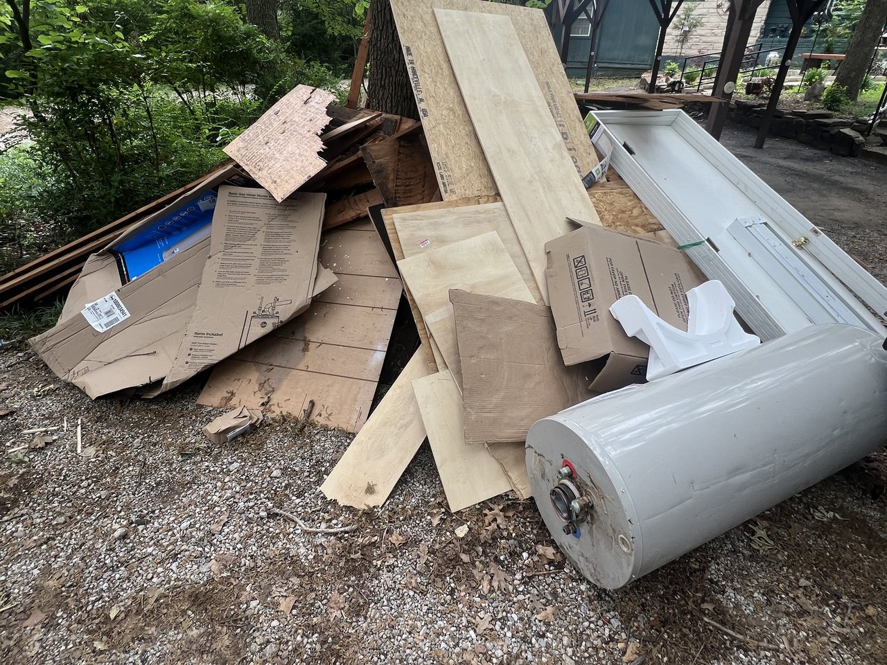 Texas Junk Boyz crew removing a refrigerator from a residential kitchen