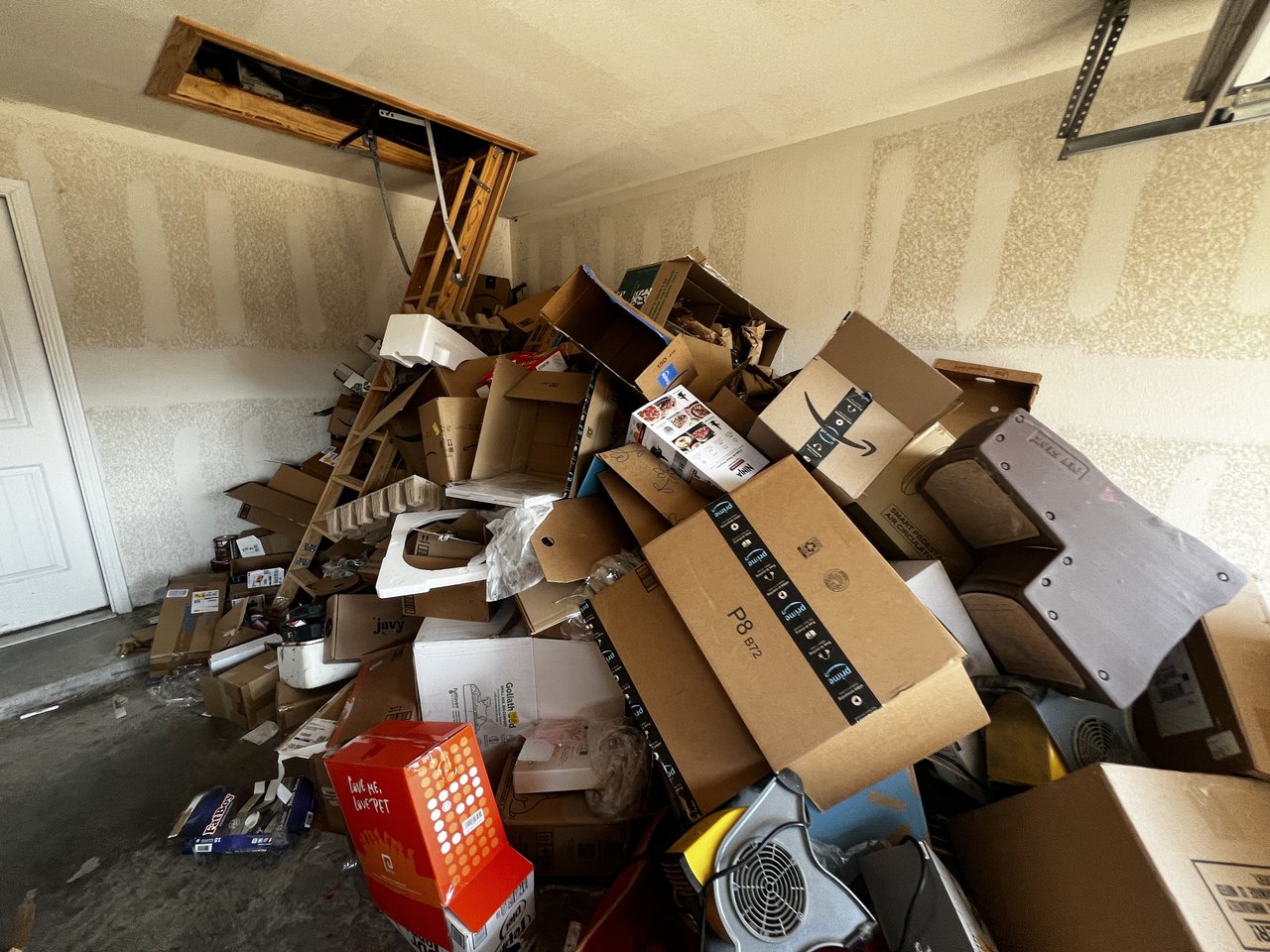 Texas Junk Boyz dump trailer at a foreclosed property mid cleanout